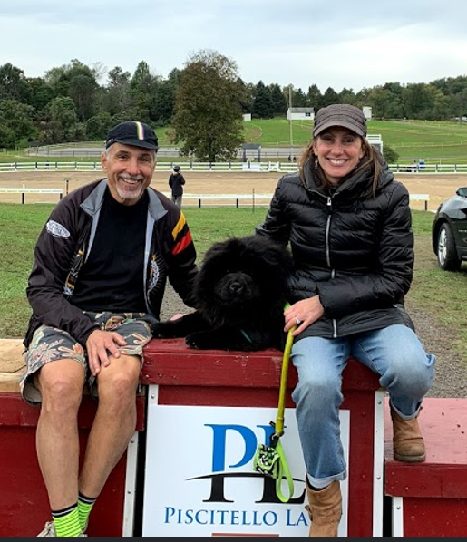 A person and person sitting on a wall with a dog

AI-generated content may be incorrect.