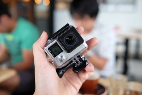 person holding a gopro camera