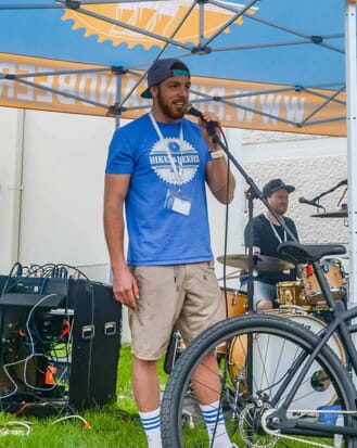 man standing next to a bike