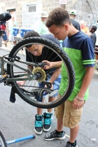 men fixing a bike