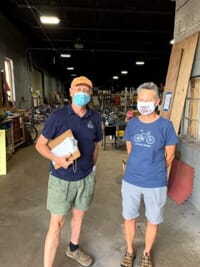 two men standing in a warehouse 